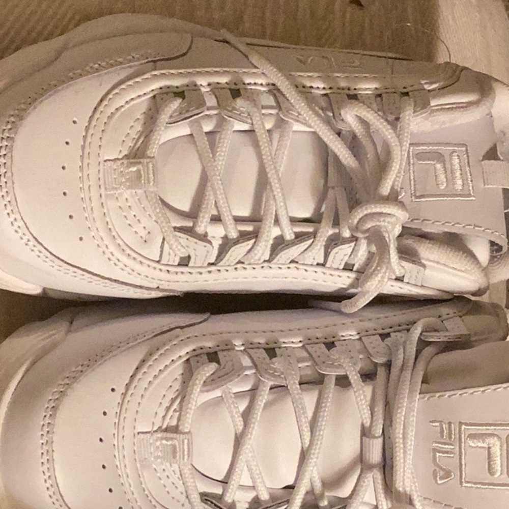 Fila woman’s sneakers.   Worn twice.  Hurt me.  A little to big so they hurt.